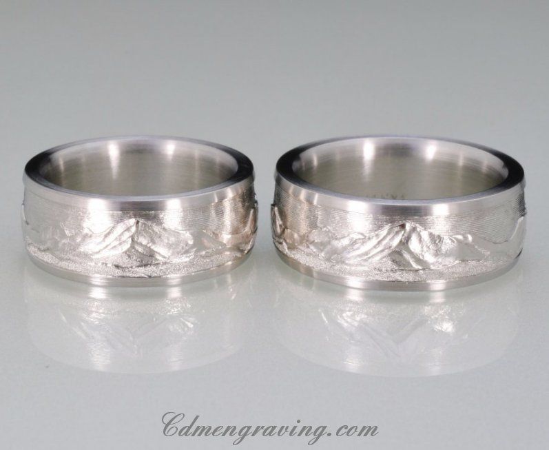 Hand engraved mountain range ring pair.