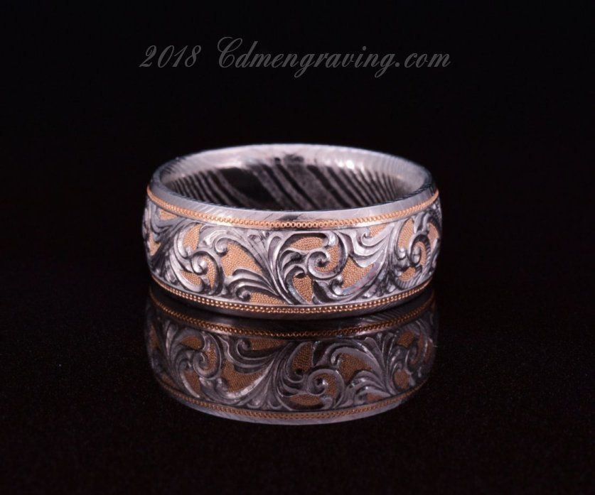 Hand engraved damascus and 18k rose gold wedding band